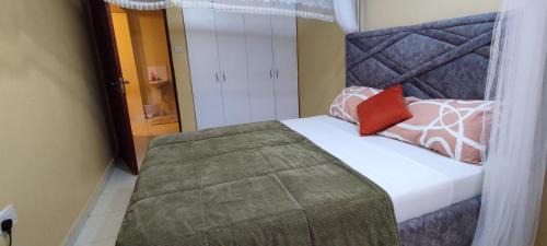 A spacious deluxe room featuring a large bed and window view